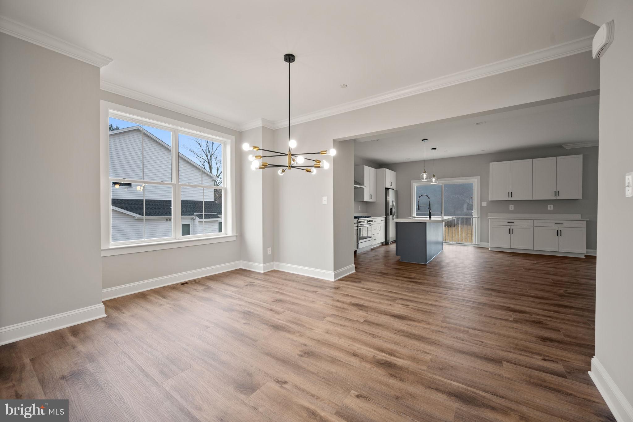 9436 Ridgely Avenue Baltimore, MD 21234 - Photo 5 of 44 a view of empty room with wooden floor and windows