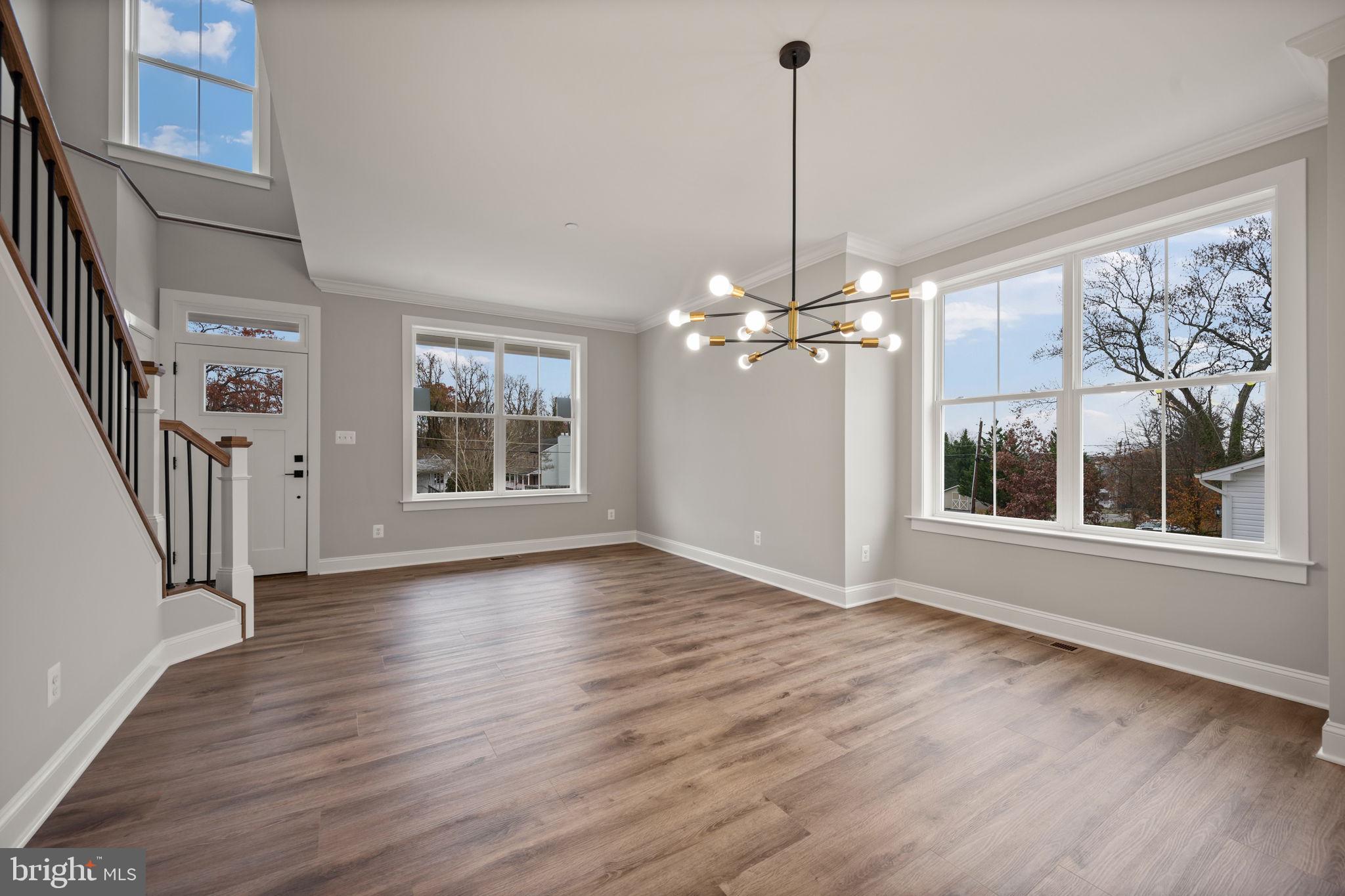9436 Ridgely Avenue Baltimore, MD 21234 - Photo 6 of 44 a view of an empty room with wooden floor and a window