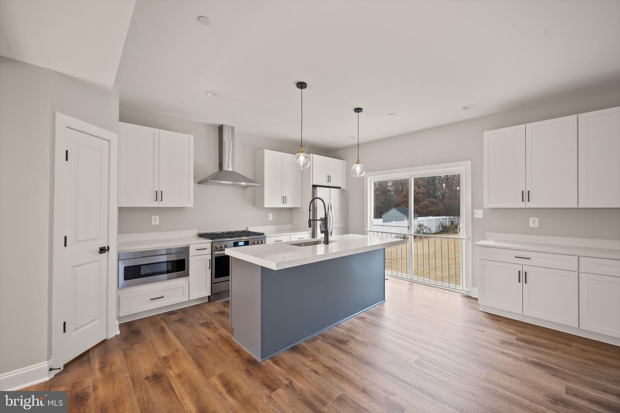 9436 Ridgely Avenue Baltimore, MD 21234 - Photo 7 of 44 a view of kitchen with granite countertop a stove top oven sink and cabinets