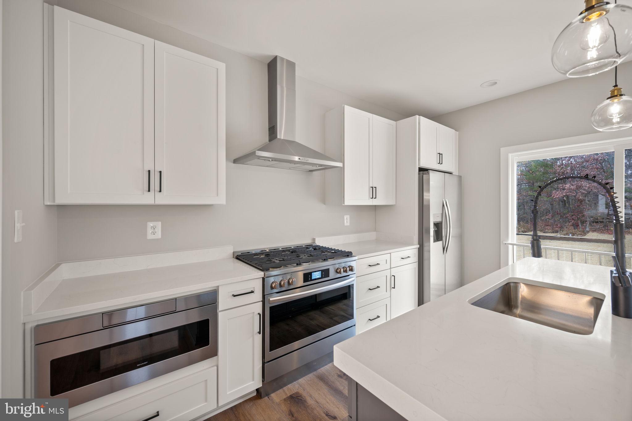 9436 Ridgely Avenue Baltimore, MD 21234 - Photo 10 of 44 a kitchen with white cabinets and white appliances