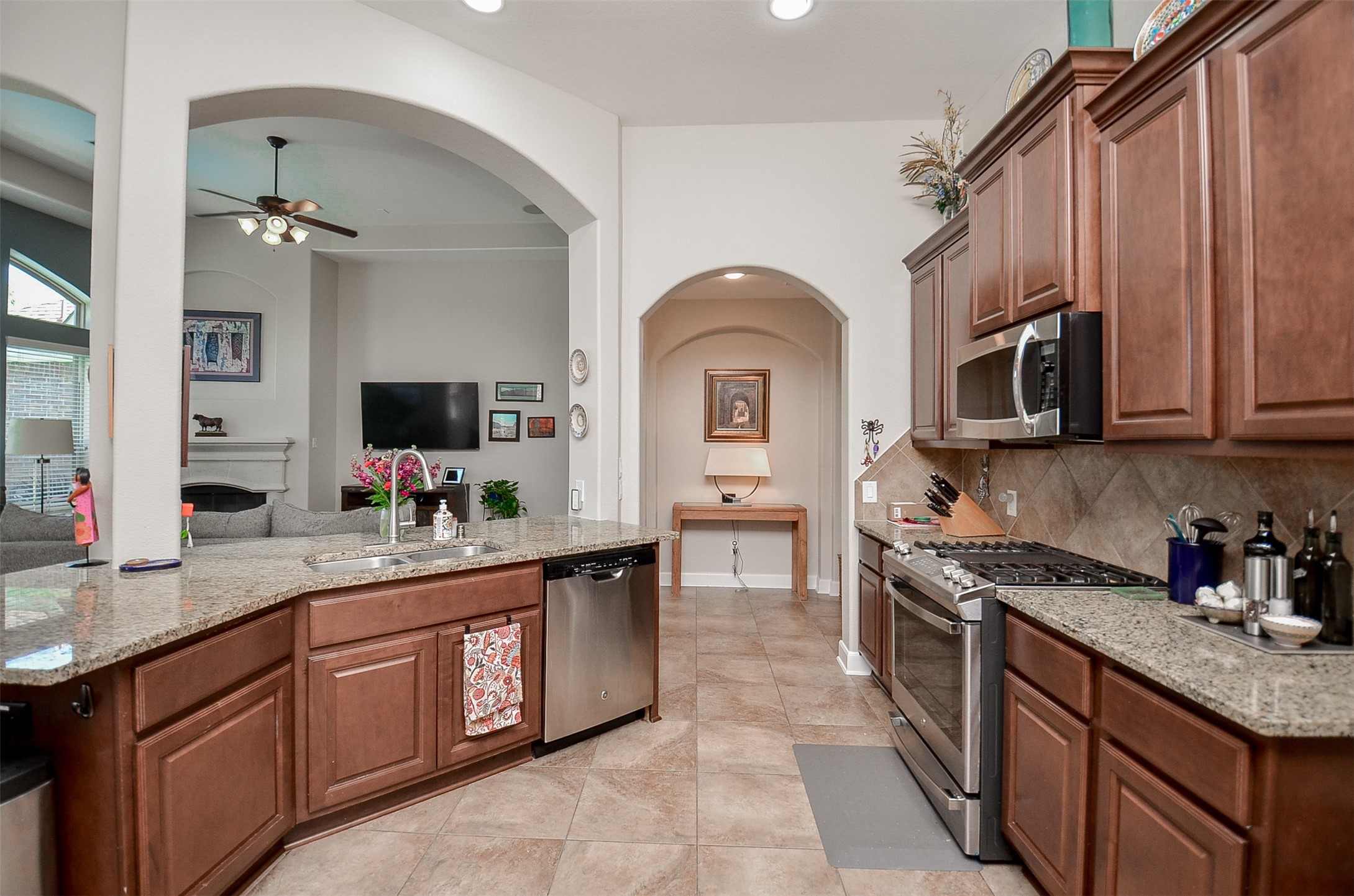 1310 Ellis Grove Lane Rosenberg, TX 77471 - Photo 14 of 38 a kitchen with a sink and a stove top oven with wooden floor