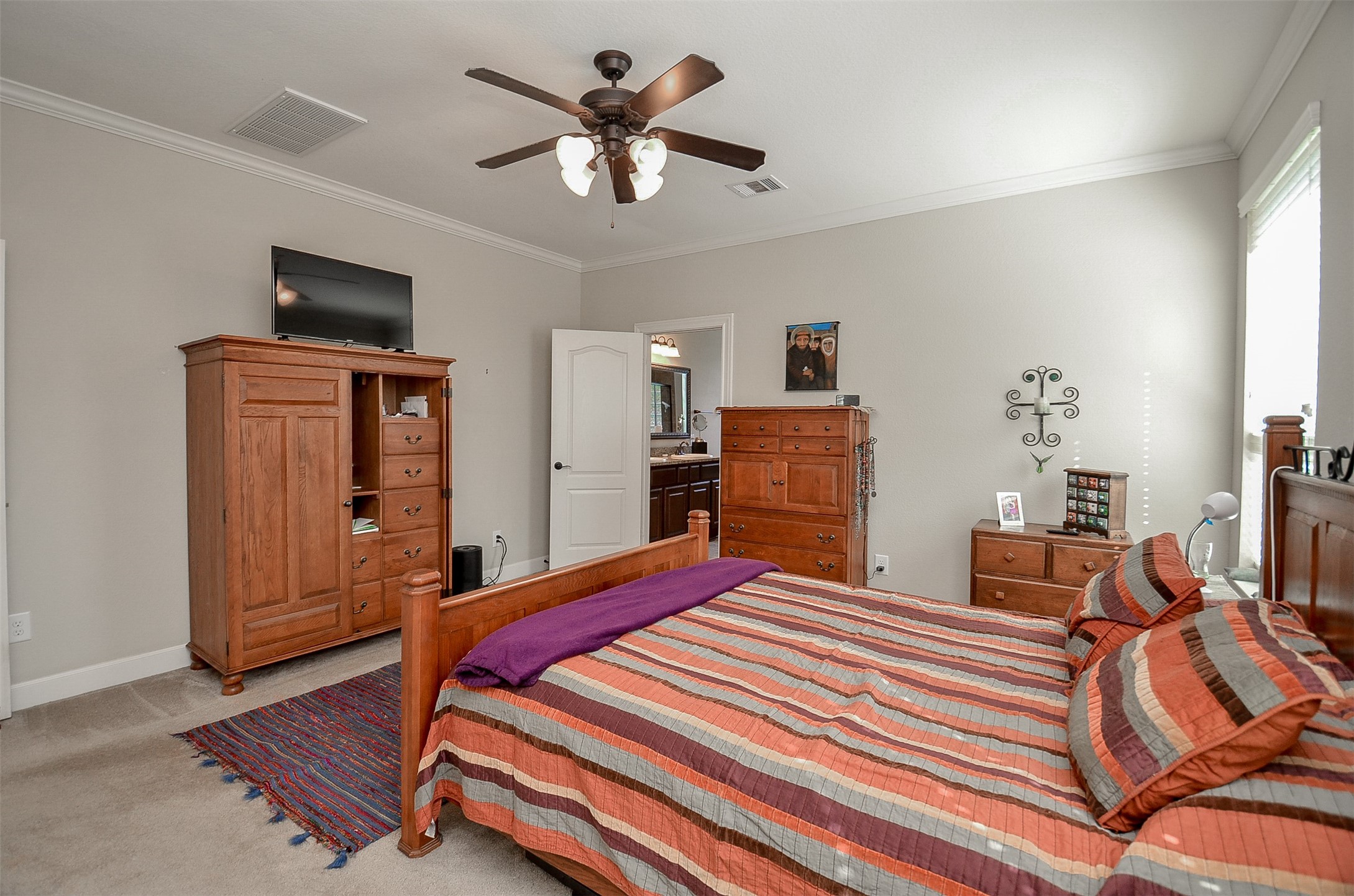 1310 Ellis Grove Lane Rosenberg, TX 77471 - Photo 19 of 38 a bedroom with a bed and a chandelier