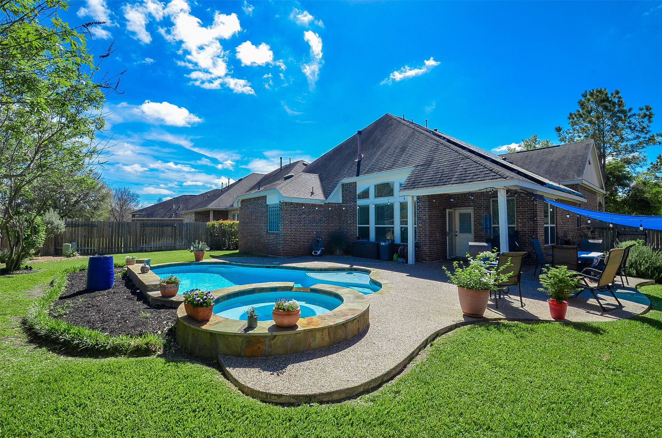 1310 Ellis Grove Lane Rosenberg, TX 77471 - Photo 35 of 38 a view of a house with backyard swimming pool and sitting area
