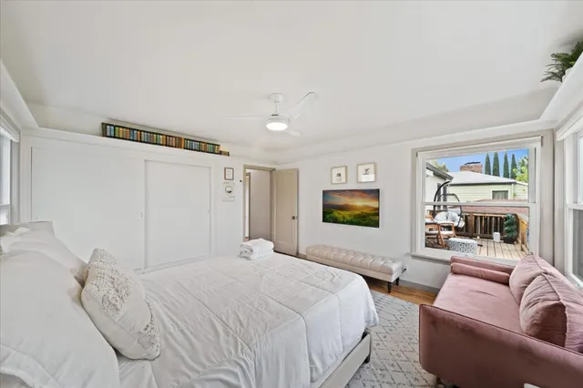 a bedroom with a balcony a bed and a flat screen tv