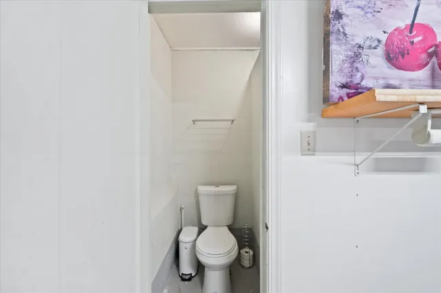 a white toilet sitting next to a bathroom sink