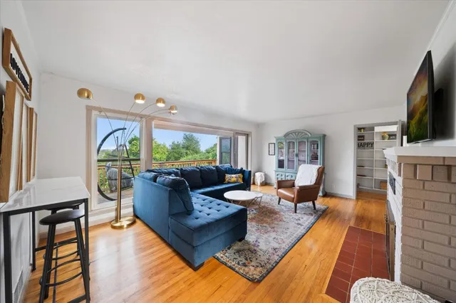 a living room with fireplace furniture and a flat screen tv