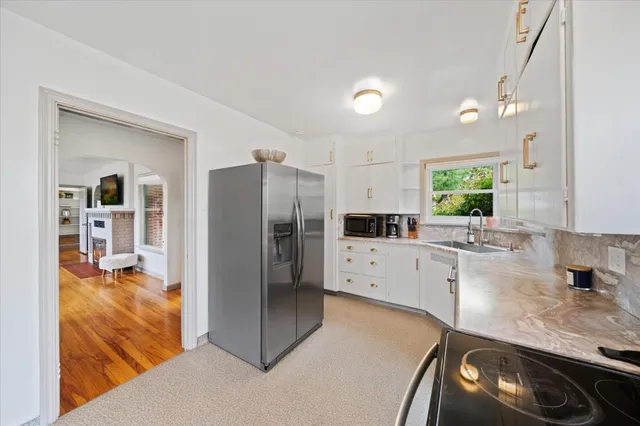 a kitchen with a refrigerator and a sink