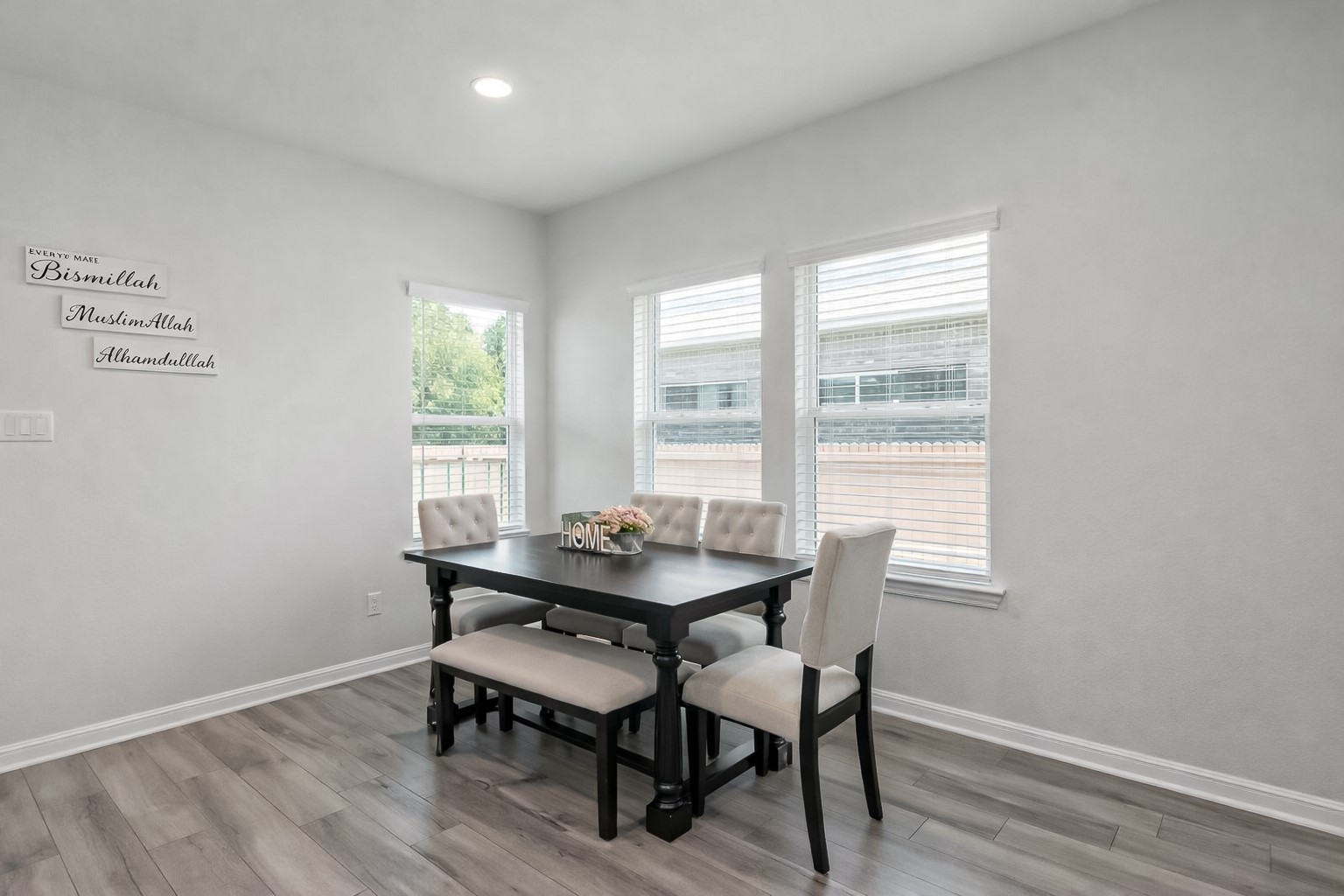 940 Paddock Lane Georgetown, TX 78626 - Photo 13 of 32 Light-filled dining area featuring wood-finish flooring, recessed lighting, and multiple windows with blinds