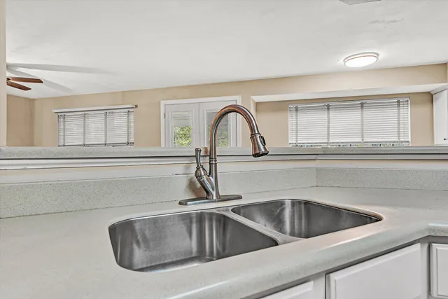 a large kitchen with granite countertop a large counter top and sink