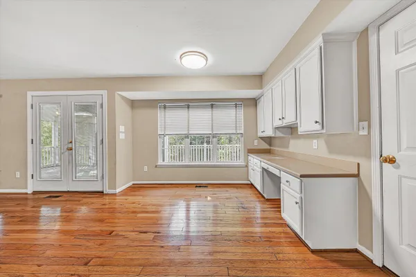 a view of a livingroom with wooden floor and a ceiling fan