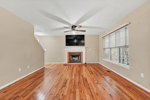 a view of balcony with wooden floor and fence