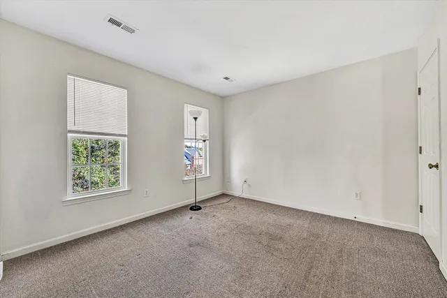an empty room with wooden floor & closet area