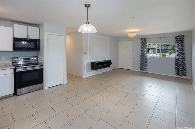 a kitchen with granite countertop a sink and a stove