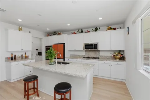 a kitchen with stainless steel appliances a stove a sink and a refrigerator