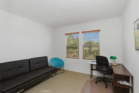 a livingroom with workspace and a window