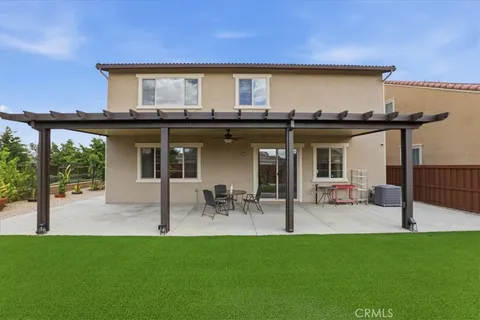 a view of a house with patio and a garden