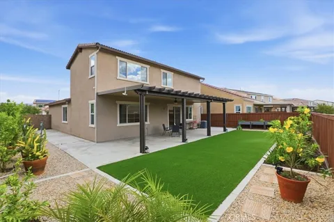 a front view of a house with a garden and plants