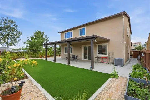 a view of a house with a backyard porch and sitting area