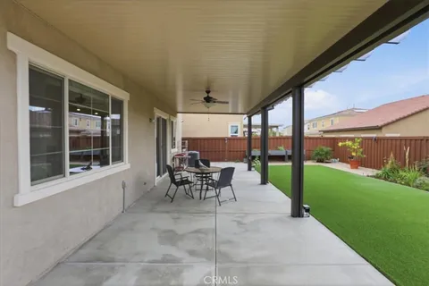a view of a porch with chairs and backyard