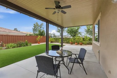 a view of an outdoor dining space with a table and chairs