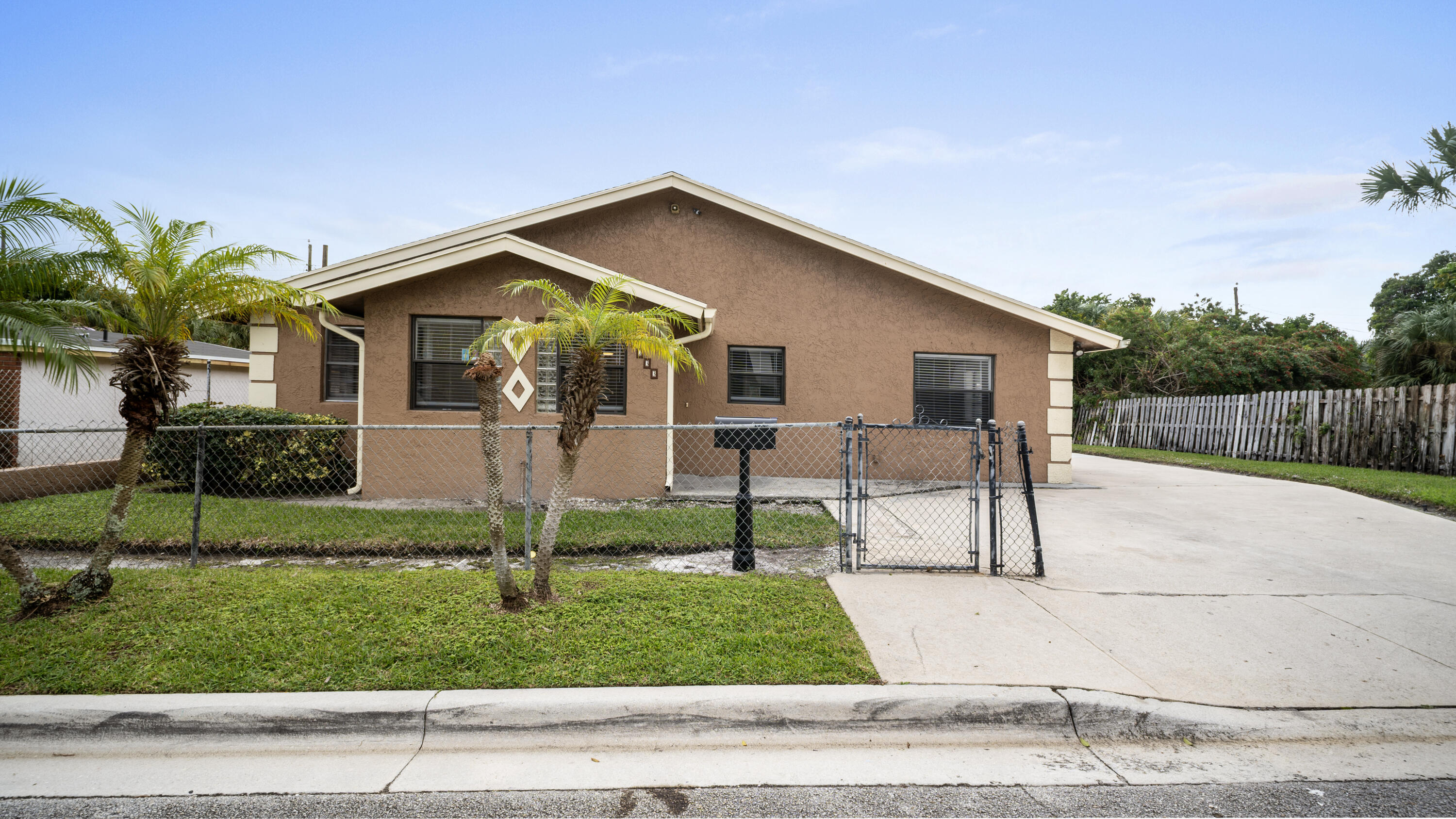 1233 West 32nd Street Riviera Beach, FL 33404 - Photo 1 of 25 a view of a house with a yard and plants