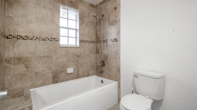a bathroom with a toilet bathtub and shower