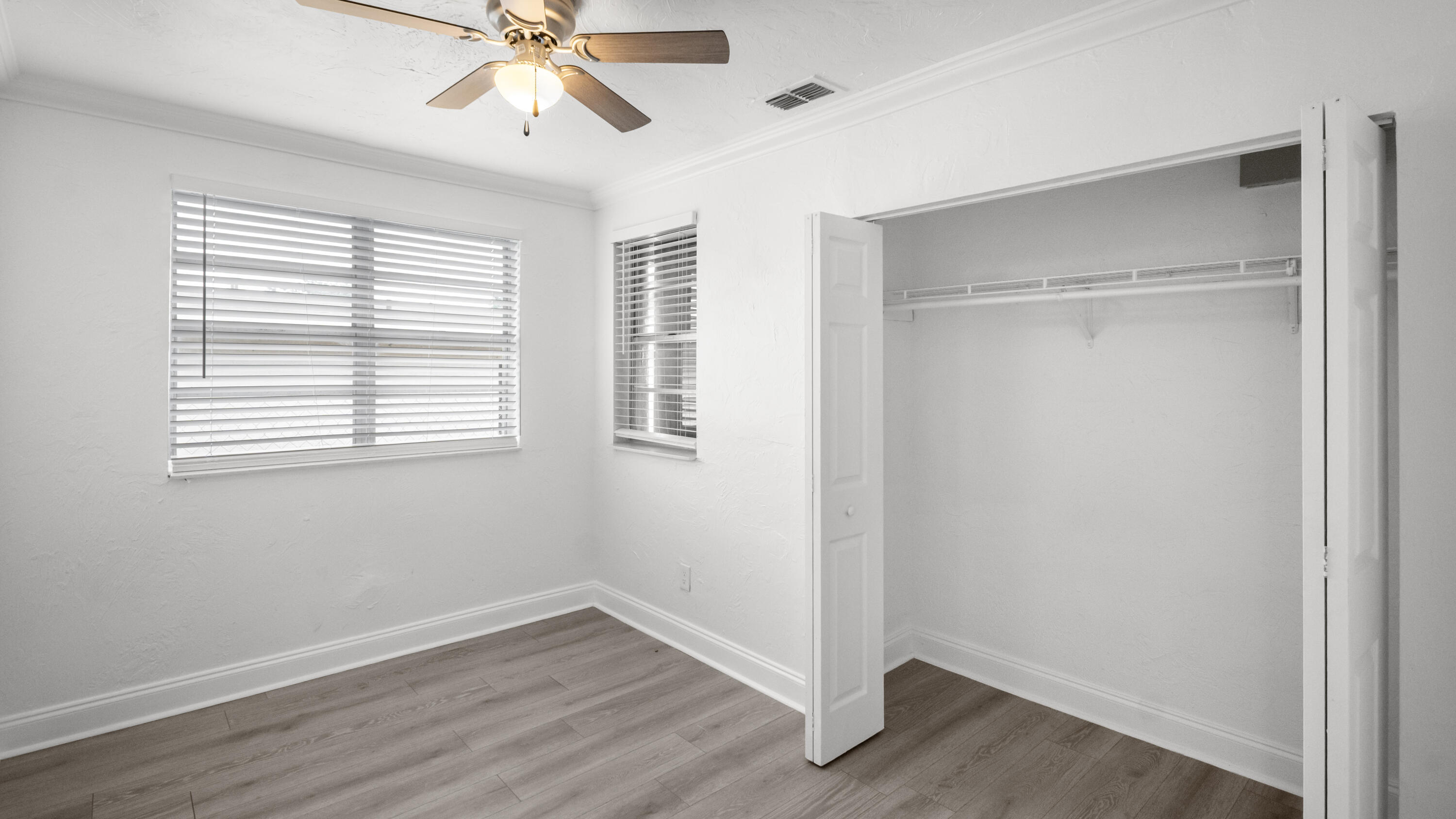 1233 West 32nd Street Riviera Beach, FL 33404 - Photo 20 of 25 a view of an empty room with wooden floor and a window