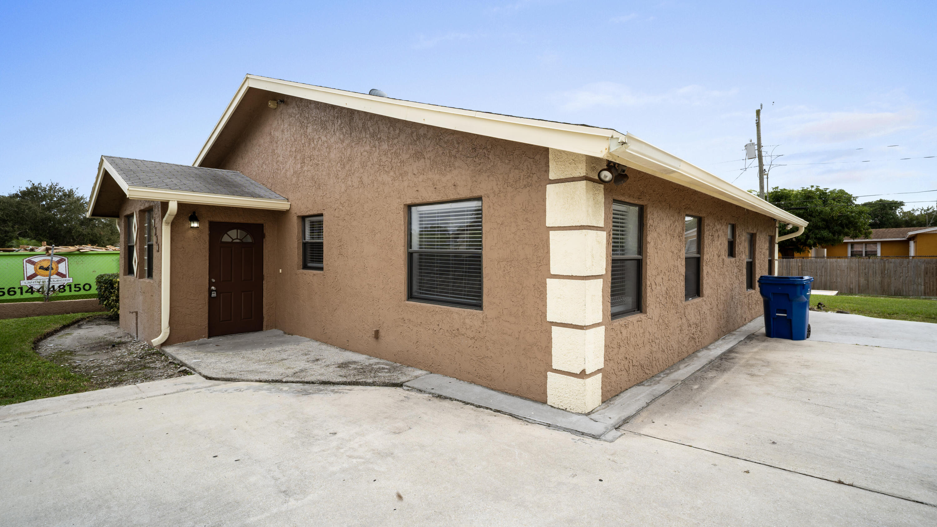 1233 West 32nd Street Riviera Beach, FL 33404 - Photo 2 of 25 a front view of a house with a porch