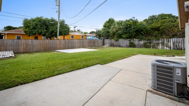 a view of a backyard with wooden fence