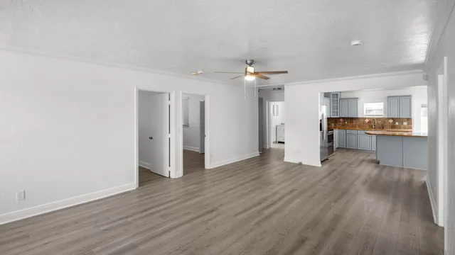a view of a kitchen with wooden floor and a kitchen