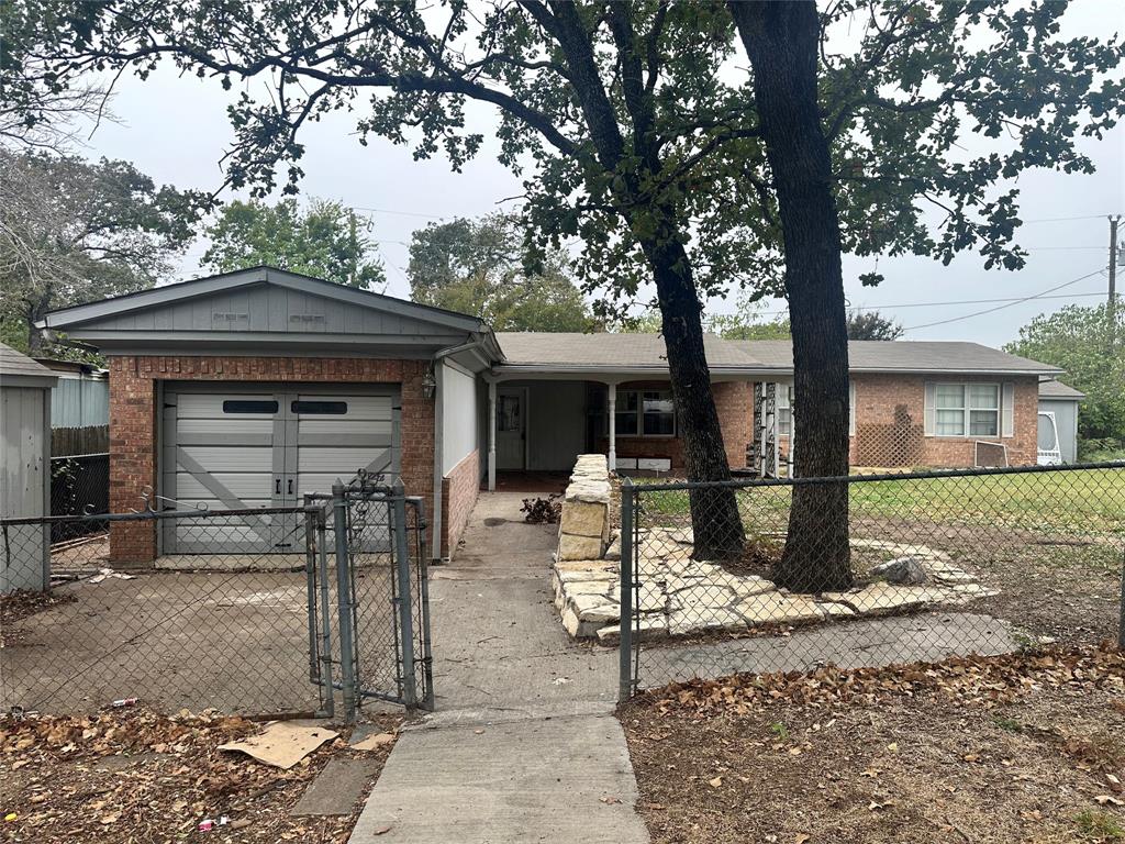 1832 Smokehouse Road Granbury, TX 76049 - Photo 1 of 1 a front view of a house with garden