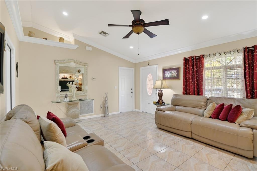 390 12th Street Southeast Naples, FL 34117 - Photo 7 of 36 a living room with furniture and a large window