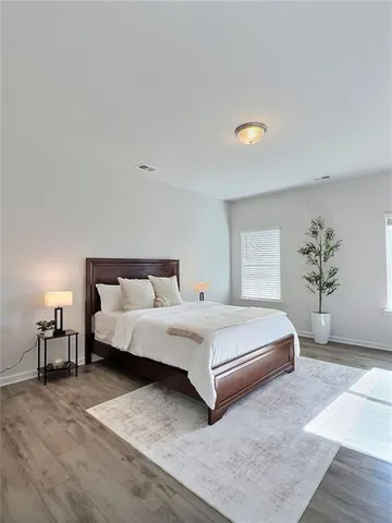 a bedroom with a bed and window