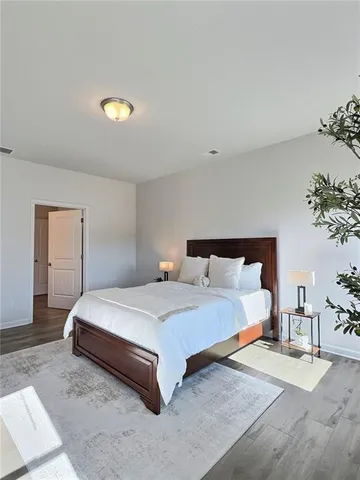 a bedroom with bed and a potted plant