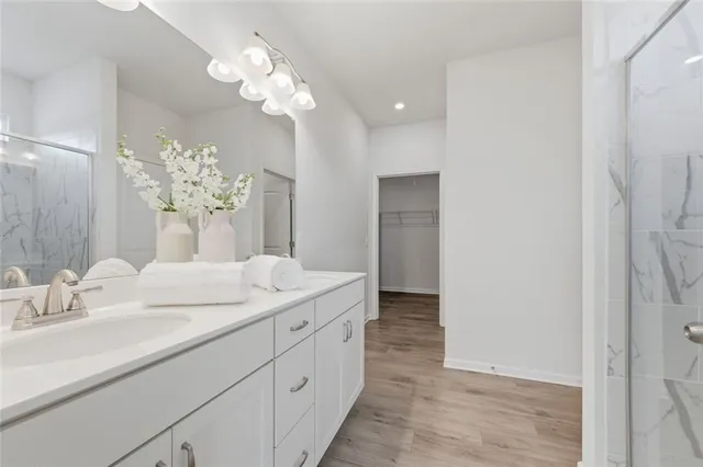 a bathroom with a sink vanity and a mirror