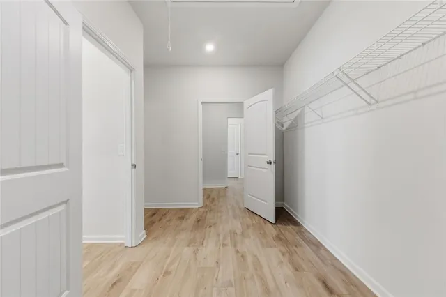 a view of a room with wooden floor and white walls