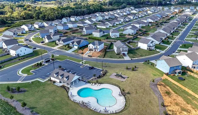 an aerial view of residential houses with outdoor space