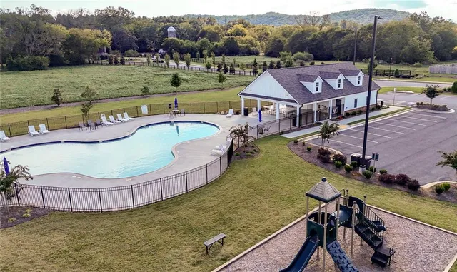 an aerial view of a house having yard and a swimming pool
