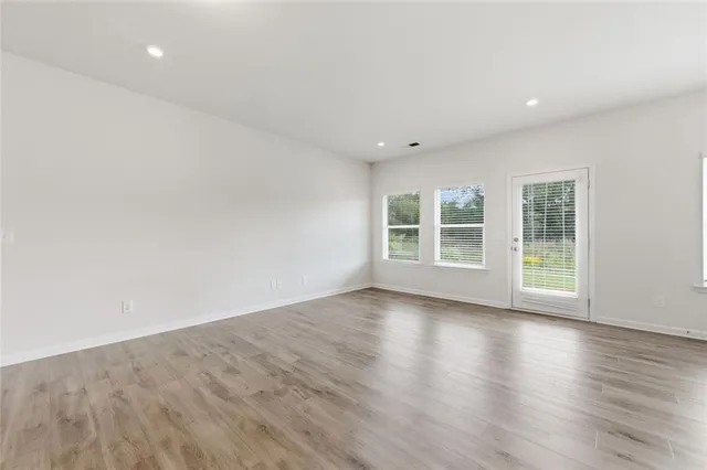a view of a room with wooden floor and window