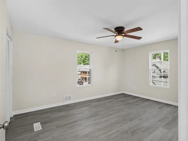 wooden floor in an empty room with a window