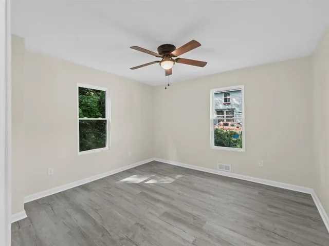 wooden floor in an empty room with a window