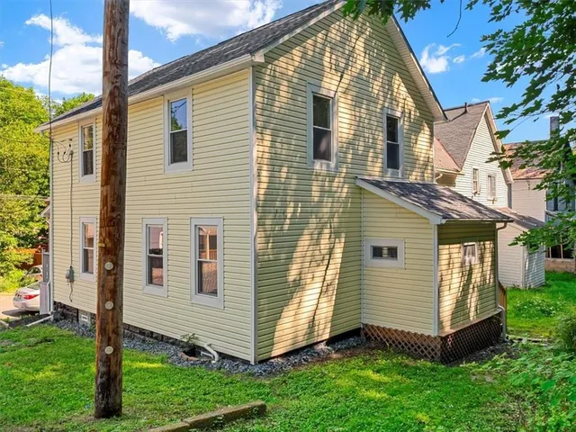 a view of backyard with barbeque grill and wooden fence