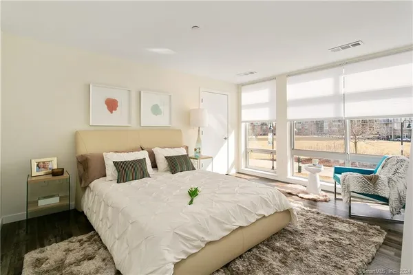 a bed sitting in a bedroom next to a window