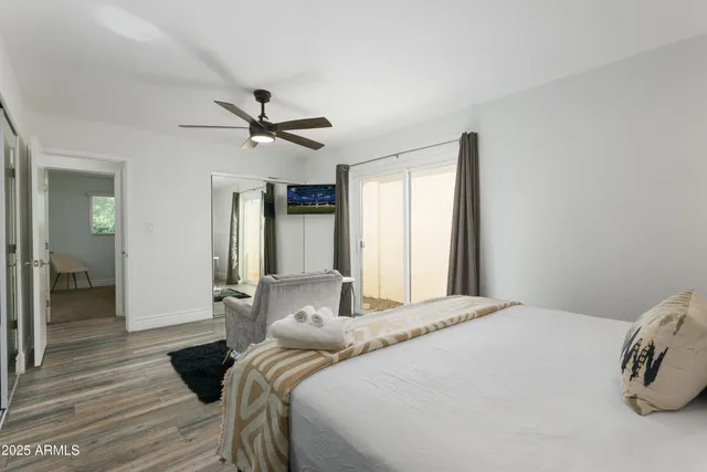 a bedroom with a bed and a ceiling fan