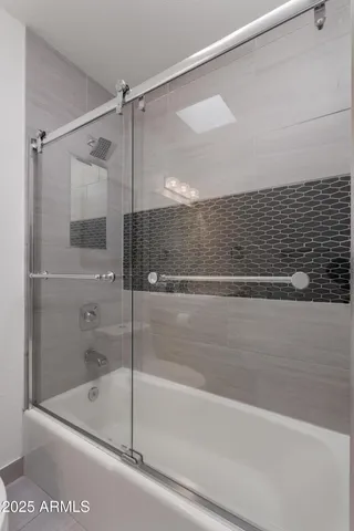 a bathroom with a shower and a bath tub