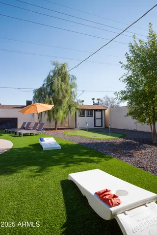a view of yard with swimming pool and green space
