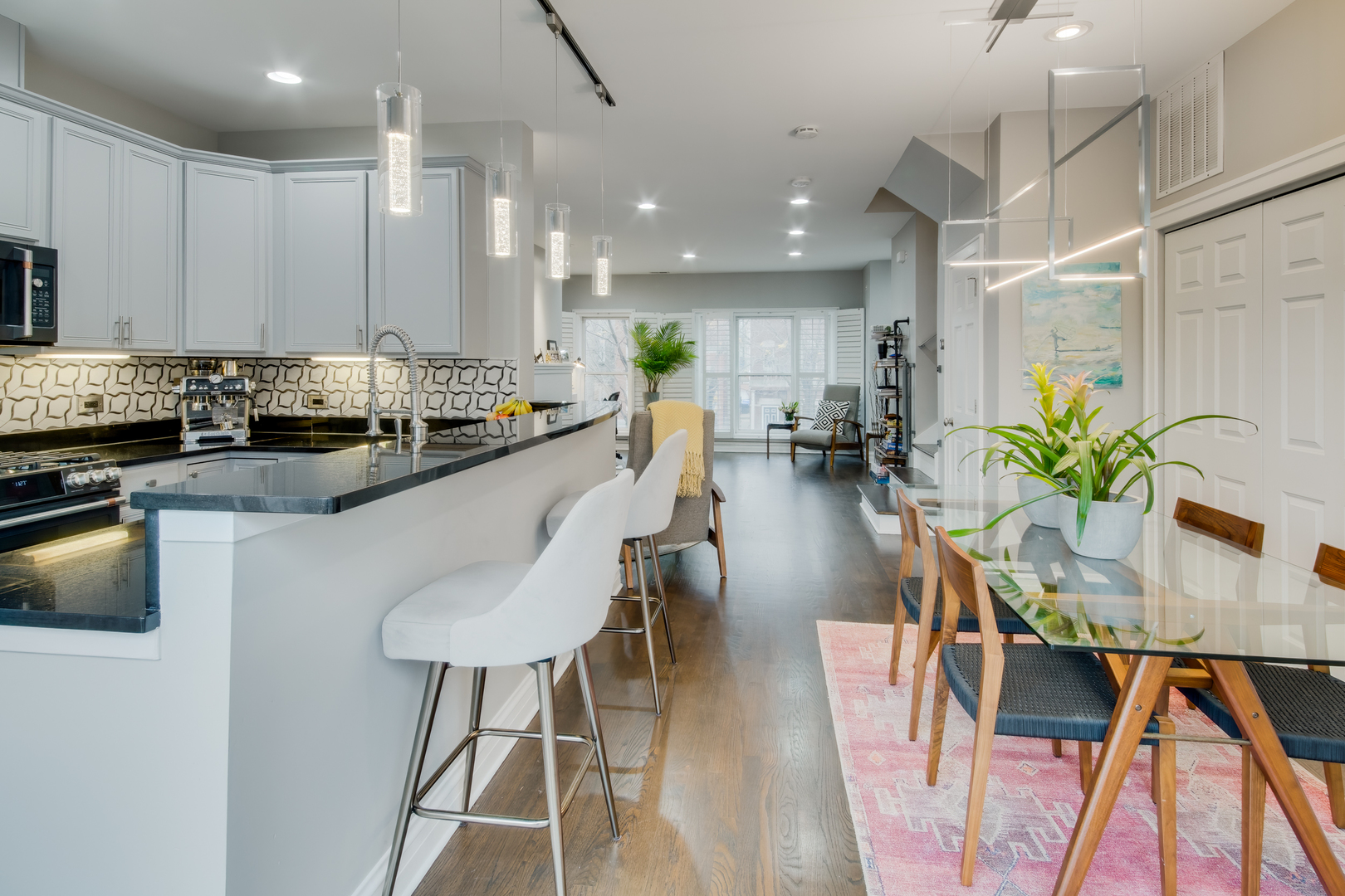 1316 West Fillmore Street, Unit B Chicago, IL 60607 - Photo 17 of 42 a kitchen with kitchen island granite countertop lots of counter top space and stainless steel appliances