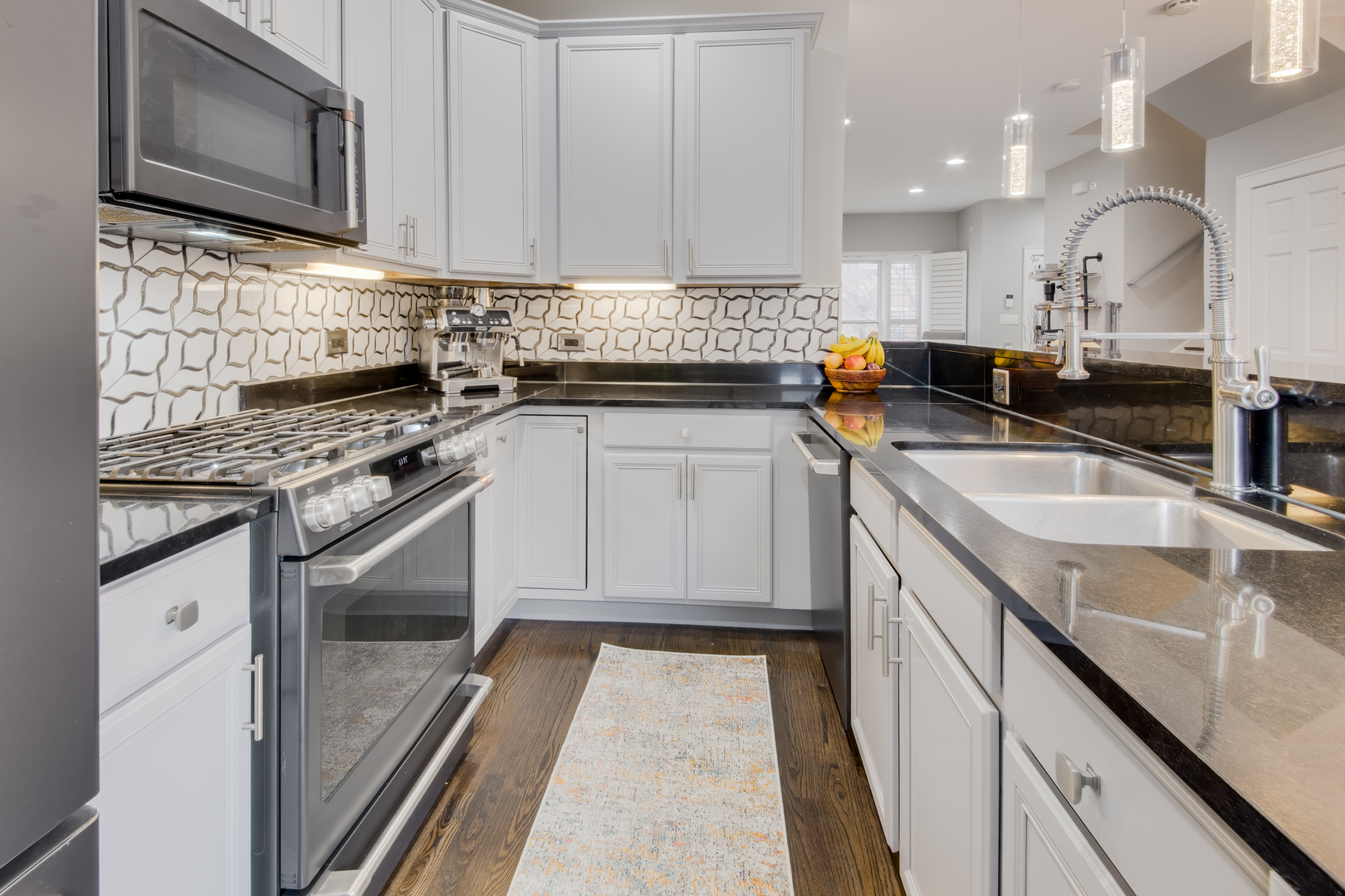 1316 West Fillmore Street, Unit B Chicago, IL 60607 - Photo 21 of 42 a kitchen with stainless steel appliances granite countertop a sink stove and microwave