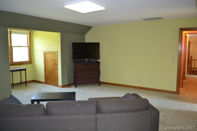483 Beacon Knoll Lane Fort Mill, SC 29708 - Photo 18 of 21 a living room with couches and a flat screen tv