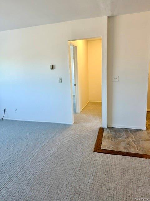 805 Plate Street, Unit 210 Rochester, MI 48307 - Photo 17 of 20 Spare room featuring light carpet and baseboards